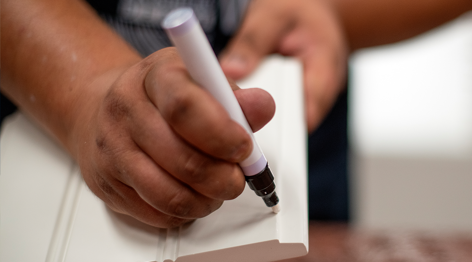 Wood cabinet finishes being matched with a color expert.